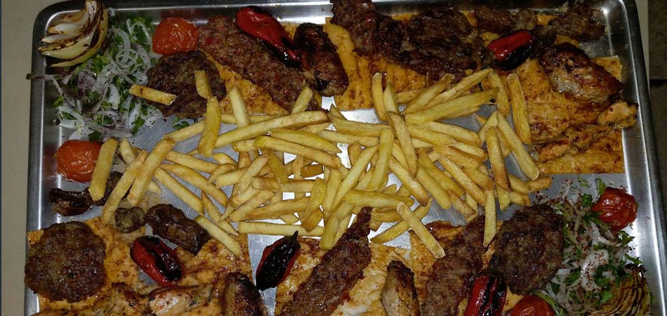 Mixed grill includes all sorts of meat and chcken with chips/fries