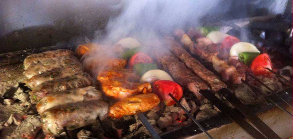 Meats and sausages grilling on the open fire