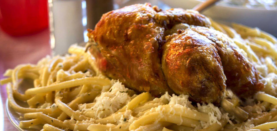 Chicken with acaroni sprinkled with grated halloumi and mint